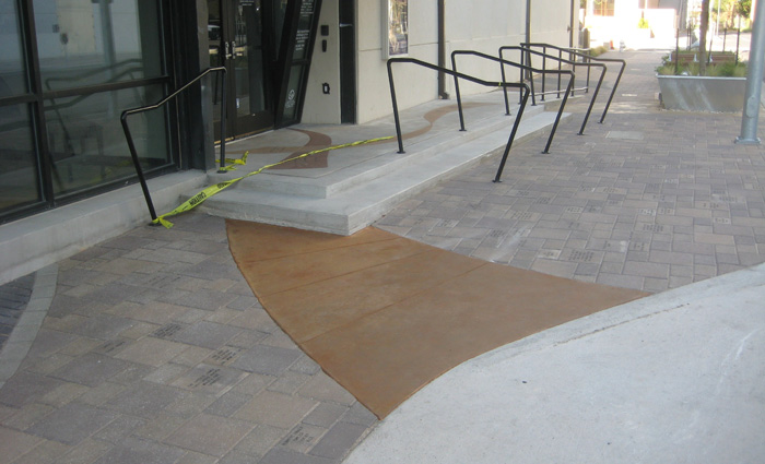 New ramp with stained concrete ribbons and handrails
